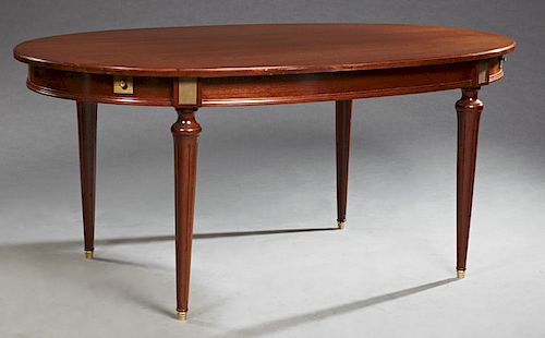 French Empire Style Ormolu Mounted Mahogany Dining Table, c. 1940, the rounded edge oval top over a wide skirt with square ormolu mounts above the tap