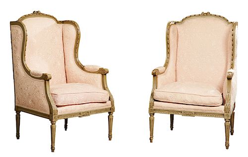 Pair of Louis XVI Style Polychromed Bergere Wing Chairs, early 20th c., the arched crest rails with floral carving above an upholstered back and reede