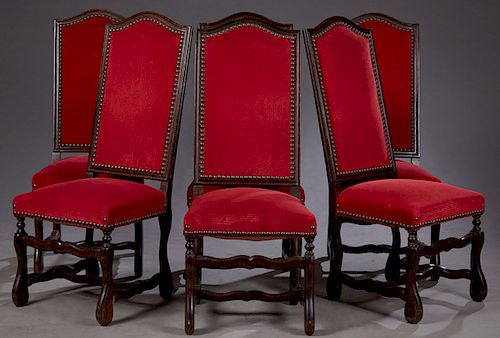 Set of Six French Louis XIII Style Carved Walnut Upholstered Highback Dining Chairs, 20th c., the arched backs over trapezoidal seats on scrolled cabr