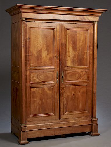French Louis Philippe Style Carved Walnut Armoire, c. 1880, the stepped ogee crown above two set back triple panel doors flanked by ormolu mounted tap