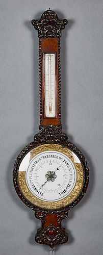 French Carved Mahogany Barometer, c. 1890, the shell carved crown over a mercury thermometer above a repousse brass framed painted glass barometer, wi
