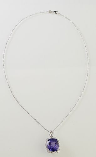 Platinum Pendant, with a 21.23 carat cushion cut tanzanite atop a border of round diamonds, with a pierced diamond mounted bail, on a platinum tiny li