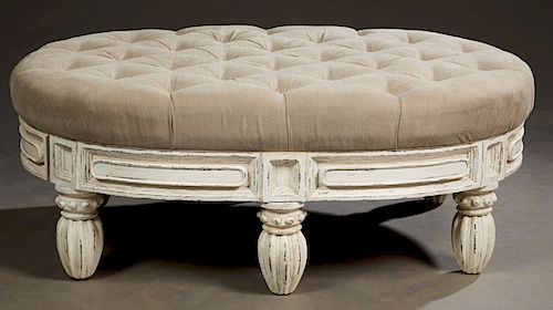 Unusual Polychromed Carved Mahogany Ottoman, 20th c., the tufted oval top over a wide lozenge carved skirt, with two end drawers, on turned tapered ba