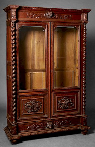 French Henri II Style Carved Oak Bookcase, c. 1880, the stepped broken arch crown over setback double glazed doors with upper glazed panels over wood 