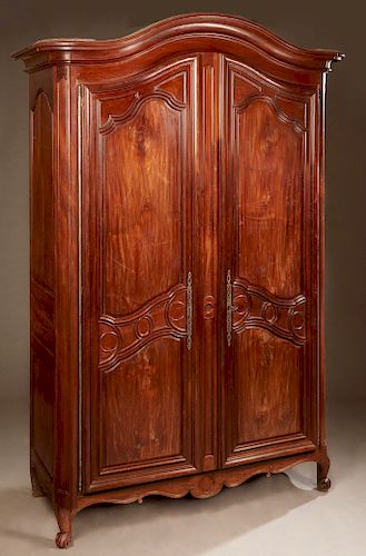 French Louis XV Style Carved Walnut Armoire, 19th c., the stepped arched crown over two arched panel doors with long steel fiche hinges and escutcheon