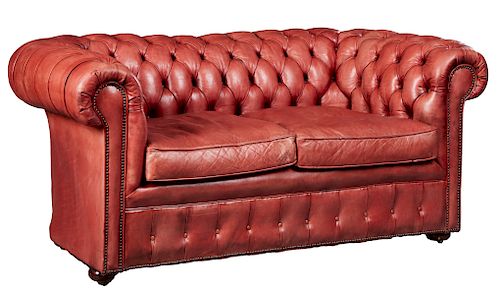 Pale Red Leather Chesterfield Two Seat Loveseat, 20th c., with a tufted back and rolled tufted arms, with iron tack decoration, with two removable cus