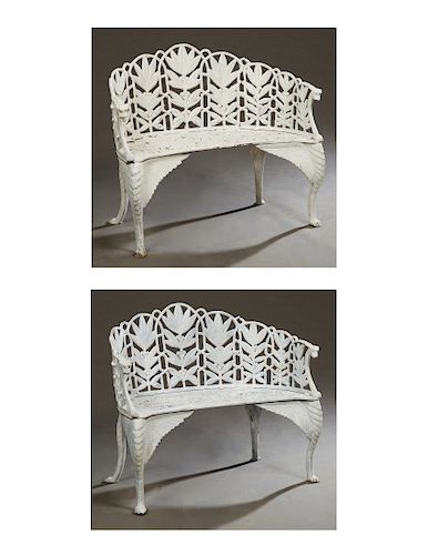 Pair of American Style Cast Iron Garden Benches, 20th c., the curved back with pierced floral decoration, to a pierced scrolled seat, flanked by arms 