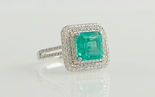 Lady's Platinum Dinner Ring, with a square 2.86 carat emerald atop a double graduated concentric border of round diamonds, the split sides of the band