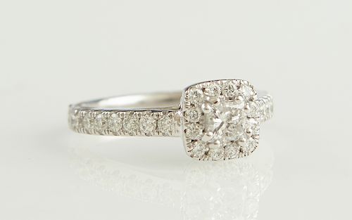 Lady's Platinum Dinner Ring, with a central round .51 carat diamond atop a square border of round diamonds, the sides of the band mounted with gradua