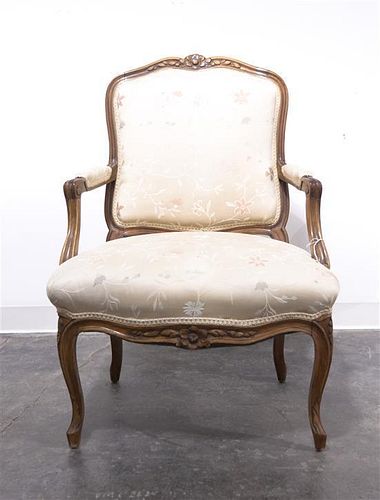A Louis XV Style Walnut Fauteuil, Height 35 inches.