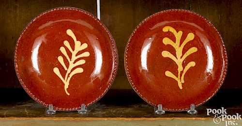Pair of Pennsylvania slip decorated redware plates