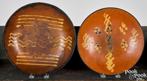 Four Pennsylvania redware slip decorated plates