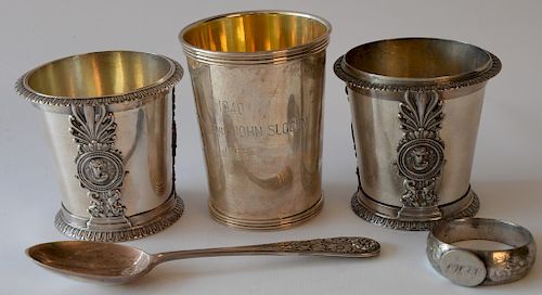 Silver lot to include three mugs including one marked John Slocum 1940, one spoon, and one napkin ring. 
18.9 troy ounces 
***If thi...