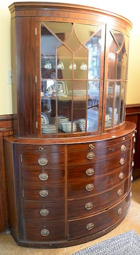 George IV mahogany demilune breakfront in two parts with two glazed doors, drawers, and pull outs. 
height 88 inches, width 67 inche...