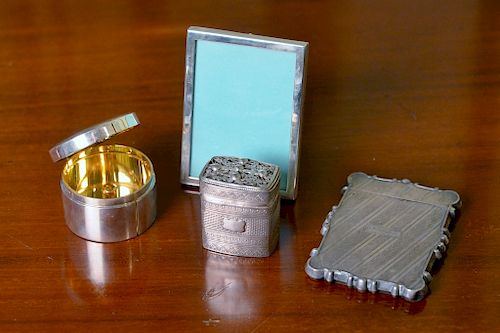 Four piece group of sterling to include Cartier roll stamp holder with gold wash interior, Tiffany & Co