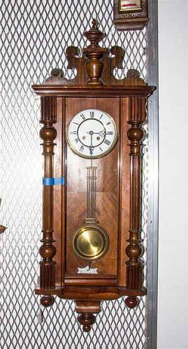 A Viennese Walnut Regulator Clock, Height 43 inches.