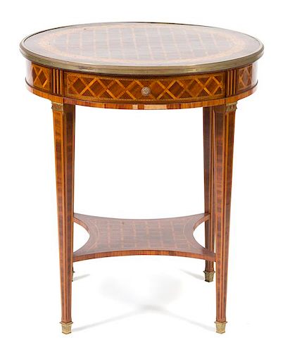 A Louis XVI Style Parquetry Inlaid Gilt Bronze Mounted Gueridon Height 29 1/2 x diameter 25 1/2 inches.