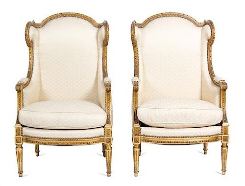 A Pair of Louis XVI Style Giltwood Wing Back Chairs Height 43 1/2 inches.