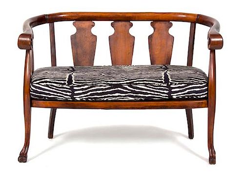A British Colonial Mahogany Loveseat and Barrel-Back Rocking Chair Height of loveseat 32 x width 45 x depth 23 inches.