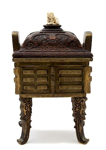 A Chinese Bronze Censer with Carved Wood Lid Height 13 x width 8 x depth 6 1/2 inches.