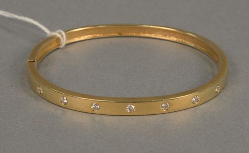 14 karat gold bangle bracelet set with seven diamonds. 16.9 grams