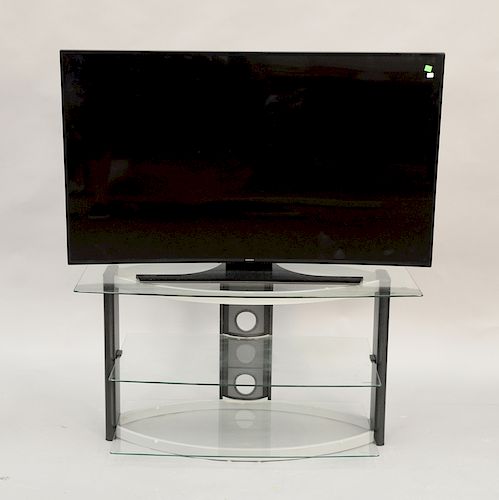 Samsung curved UHD 55 inch TV, three tier glass stand, and miscellaneous electronics, ht. 24 in.