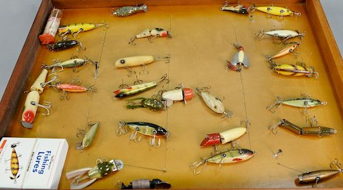 Twenty-seven various vintage fishing plugs in display case. lg. 3 in. to 7 in.