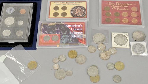 Coin collection including 1963 mint proof set, 4 Indian head pennies, nickel, 3 silver quarters, 2 half dollars, and 4 silver dollars.