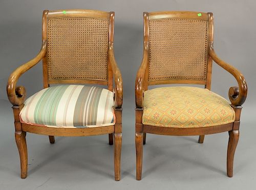 Pair of fruitwood caned back armchairs.