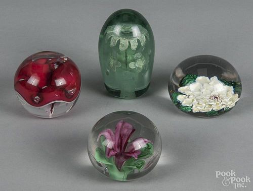 Four assorted floral glass paperweights, largest - 3 3/4'' dia.