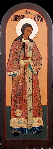 Large Russian Icon, 20th c., of a female Saint holding a box, gilt and egg tempera on arched panel, H.- 63 in., W.- 23 in., D.- 1 in.