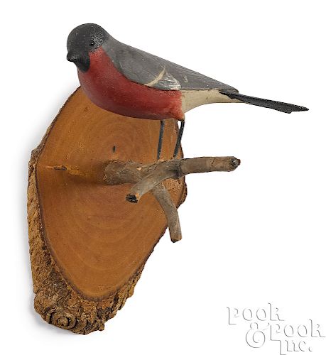 Carved and painted bird on a twig branch