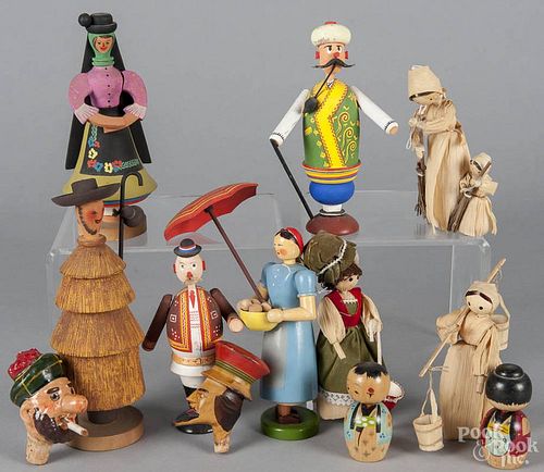 Group of painted wooden ethnic dolls, to include a German woman, two Eastern European men