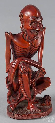Oriental carved and stained figure of an emaciated man, 6'' h.