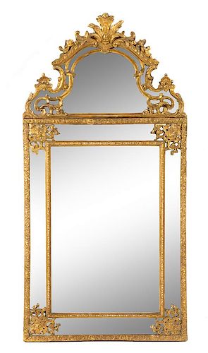 A Regence Style Giltwood Mirror Height 56 3/4 x width 28 1/2 inches.