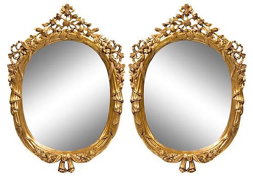 A Pair of Carved Giltwood Mirrors Height 49 x width 35 inches.