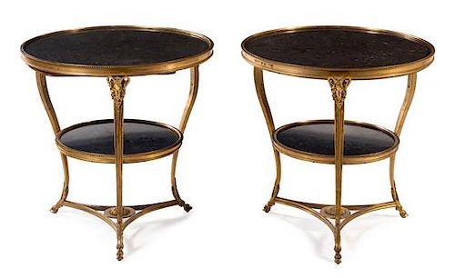 A Pair of Neoclassical Gilt Bronze Gueridons Height 27 1/2 x diameter of top 28 inches.