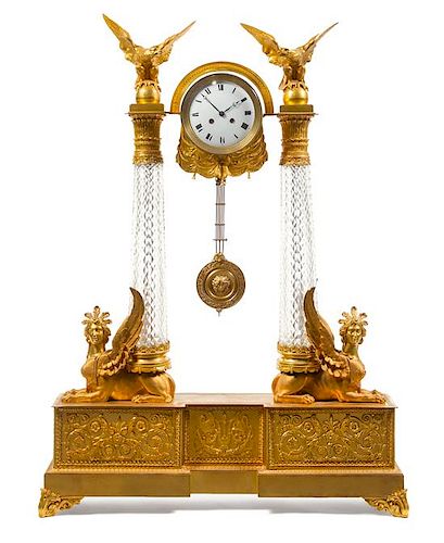 An Empire Style Gilt Bronze and Cut Glass Clock Height 44 1/4 x width 31 3/4 x depth 7 inches.