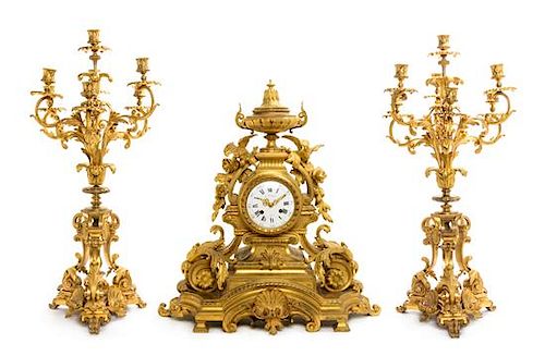 A Louis XV Style Gilt Bronze Clock Garniture Height of mantel clock 25 1/2 inches.