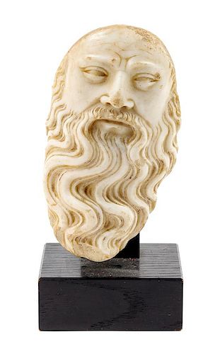 * A Continental Carved Marble Mask Height 5 3/4 inches.