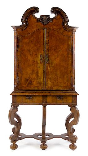 * A Continental Walnut Cabinet on Stand Height 85 3/4 x width 43 x depth 15 1/4 inches.