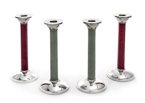 A Set of Four English Silver Candlesticks, Asprey Ltd., London, 2007, the candle cups above the leather-wrapped stem, each raise