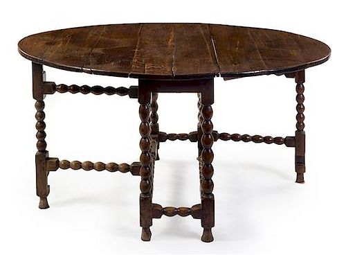 A William and Mary Oak Drop-Leaf Table Height 29 1/2 x width 46 x depth 16 inches.
