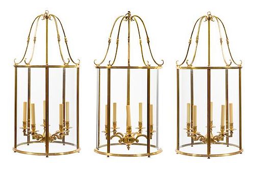 A Set of Three Brass Five-Light Hall Lanterns Height 50 inches.