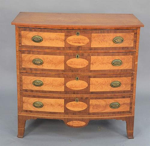 Federal bowed front four drawer chest with figured maple paneled drawer fronts and drop center, brasses having head of eagle with sn...