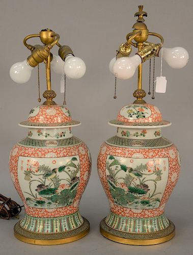Pair of E.F. Caldwell Chinese famille verte covered jars made into table lamps with pleated silk shades, bronze base marked: E.F. Ca...