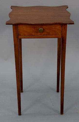 Federal cherry one drawer stand having shaped top set on square tapered legs, circa 1800. 
height 27 1/2 in., top: 16 1/8" x 16 1/4"