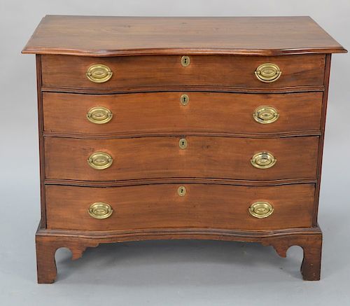 Cherry four drawer chest having molded overhanging top over conforming serpentine drawers set on bracket feet. 
height 33 in., width...