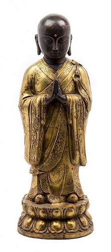 A Gilt Bronze Figure of a Monk Height 18 1/2 inches.