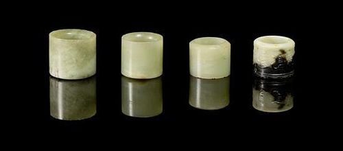 * A Group of Four Jade Archer's Rings Diameter of widest 1 1/4 inches.